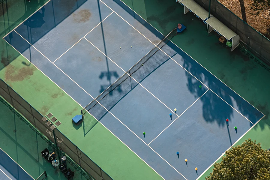 Aerial view of young people exercising on the tennis court.